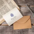 Retro white greeting card featuring a purple leaf motif and brown kraft paper envelope set - Monstera Style