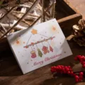 Elegant white tri-fold Christmas greeting card with hand-drawn holiday ornaments - Christmas Ornament Style