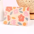 Tarjeta de felicitación floral en acuarela con texto dorado Sinsoledad en fondo cálido - Felicidad En Tus Manos (Pintura al Óleo Estampado en Oro)