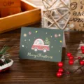 Festive green Christmas card with gold-stamped Merry Christmas and Santa illustration. - Santa Giving Gifts / 10 Sheets Set