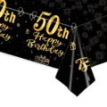 Close-up of a 50th birthday tablecloth featuring golden fireworks and balloon designs. - 50th Birthday / 137x274cm