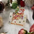Vintage Weihnachts-Geschenkkarte mit Weihnachtsmann und Rentier auf Holz - Weihnachtskollektion - Schlitten Sternenreise