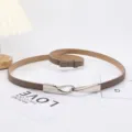 Slim adjustable brown leather belt for women featuring a minimalist silver buckle - Khaki