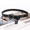 Elegant black leather belt for women featuring a stylish heart shaped silver chain link buckle - Black