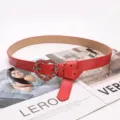 Stylish red leather belt for women featuring a chic silver heart-shaped chain buckle design - Red