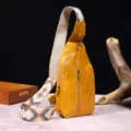 Detalle de un bolso bandolera vintage amarillo mostaza con una correa ancha estilo boho - Amarillo