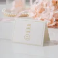 Detalle de pequeña tarjeta de felicitación blanca con texto LOVE dorado y una cara - Love Love Love