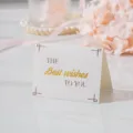Elegante tarjeta de felicitación plegada con texto dorado 'Best wishes' en mármol. - Mis Mejores Deseos Para Ti
