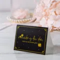 Pequeña tarjeta de felicitación negra doblada con letras doradas 'romantic as the star' - Warm Like Sunset Bright Like Starlight