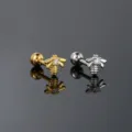 Detailed macro shot of golden and silver bee stud earrings with clear zircon stones - Bee Style (CC169) / Silver