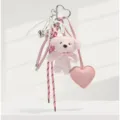 Detailed view of fluffy pink teddy bear keychain featuring lovely pearl bow and heart charm. - 26cm / 60g / Pink