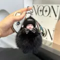 Cute black plush sleeping baby doll keychain, fluffy pompom bag charm for car keys. - Black (14cm / 37g)