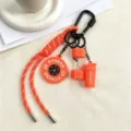 Fitness themed keychain detail, featuring orange paracord and cute dumbbell charms. - Orange
