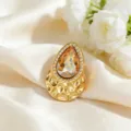 Luxury water-drop amber zircon brooch in gold-plated stainless steel with hammered texture - Amber
