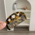 Detailed macro view of a portable tortoise shell acetate comb with cute heart cutouts - Heart Cutout Half Moon Comb / Small (8.8x4.8cm) / Dark Leopard Print
