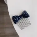 Detailed view of navy blue polka dot acetate bow hair comb for elegant styling - Deep Blue Polka Dot Comb / Dark Blue