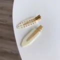 Set of two minimalist white hair clips with red polka dots and gold-tone metal clips - Beige