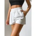 Close-up detail of women's white high-waisted elastic waist loose sports shorts - S / Bottoms / White