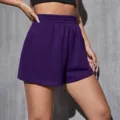 Detailed view of high-waisted purple sports shorts with elastic waist for women - Purple