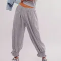 Detail shot of striped casual pants with elastic waist and cute ruffle cuffs for summer. - Gray