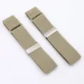 Close-up detail shot of khaki elastic shirt sleeve garters with metal adjustable clips. - Khaki