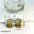 Close-up view of gold stainless steel striped stud earrings with size and weight markers - Horizontal Striped Geometric Oval (ES830)