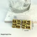 Detail view of gold geometric striped stainless steel earrings with 2.3cm size markings - Vertical Striped Geometric Square (ES831)
