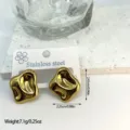 Close-up detail of golden geometric stainless steel earrings showing dimensions and weight - Dynamic Irregular Geometric (ES833)