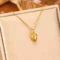 Close-up detail of a minimalist gold strawberry pendant on a delicate chain necklace. - Small Gold Pinecone / Gold