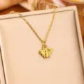 Detailed macro view of a golden bumblebee pendant on a delicate chain necklace - Golden Cicada / Gold