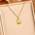 Detailed macro view of a delicate gold ladybug pendant necklace on a beige display. - Gold Ladybug / Gold