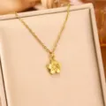 Close-up of the elegant gold cherry blossom pendant on a fine necklace chain - Gold Petals / Gold