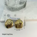 Detailed macro view of gold-tone stainless steel ribbed geometric stud earrings. - Vertical Striped Geometric Square (ES857)