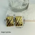 Elegant gold-tone striped geometric stainless steel earrings with 2.95cm height. - Diagonal Striped Rectangular Geometric Style (ES864)