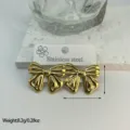 Golden striped stainless steel bow earrings, stylish geometric jewelry for women - Striped Embossed Bow (ES871)