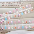 Detailed view of children's press-on nails featuring cute cartoon cow and candy patterns - Sweet Orange Cute Cow (T577) / 30 Packs