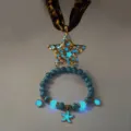 Detailed view of a glowing star necklace and starfish bracelet with luminous beads. - Necklace Bracelet Set / Gold (Blue Light)