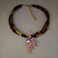 Luminous conch necklace with leopard print band and glowing gold seashell pendant. - Necklace / Gold Magenta