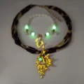 Detail of luminous golden conch necklace with leopard print ribbon and glowing beads. - Necklace Bracelet Set / Gold Orange Red