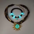Detail of luminous jewelry set with leopard strap and gold sun pendant glowing in blue. - Gold Cyan Glow Necklace Bracelet Set