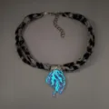 Detailed macro view of the luminous jellyfish pendant on a leopard print ribbon necklace. - 6# White Gold-Toned Blue Glow Necklace