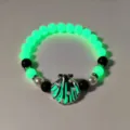 Glowing green beaded bracelet with a pearl-inlaid metallic seashell charm detail - 17#白K绿光手串