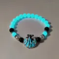 Luminous beach bracelet featuring cyan glowing beads and metallic shell detail. - 18#白K兰绿光手串