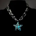 Detailed macro view of a luminous star pendant with leopard print ribbon cord necklace - Necklace / White K (Blue Light)