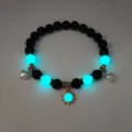Close-up detail of luminous blue beads and gold sun charm on a stylish beach necklace - Gold Teal Light Bracelet