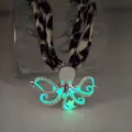 Detail shot of glow-in-the-dark octopus pendant necklace with leopard pattern strap - White K Green Glow Necklace