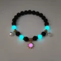Detail of luminous summer beach necklace featuring glow-in-the-dark sun and shell pendants - Gold Rose Red Light Bracelet