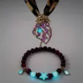 Detailed macro view of glow-in-the-dark jellyfish pendant and matching beaded star bracelet - 20# Gold-Tone Rose Red Necklace & Bracelet Set