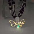 Close-up of a luminous octopus pendant necklace with ocean theme glowing in a dark environment - White K Orange-Red Glow Necklace