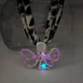 Close-up detail of a luminous purple octopus pendant necklace with leopard print strap - White K Rose Red Glow Necklace